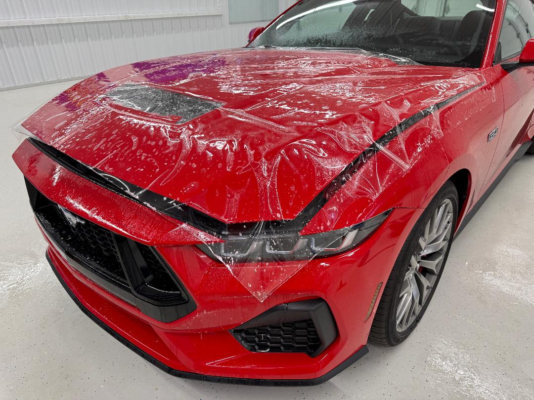 Clint Allerton Blog What to Look for PPF Installer Opti-Coat Ultra PPF being installed on a red Ford Mustang